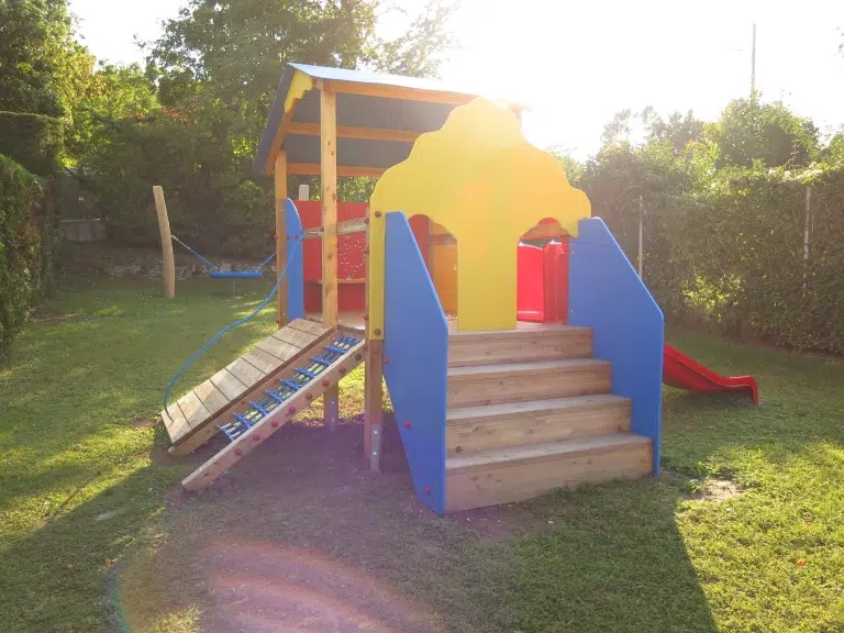 Spielgerät mit Rutsche und Kletternetz und Stiege
