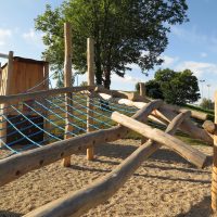 Kletteranlage Lars mit viel Holzpalisaden auf Kiessand für Kinder gebaut